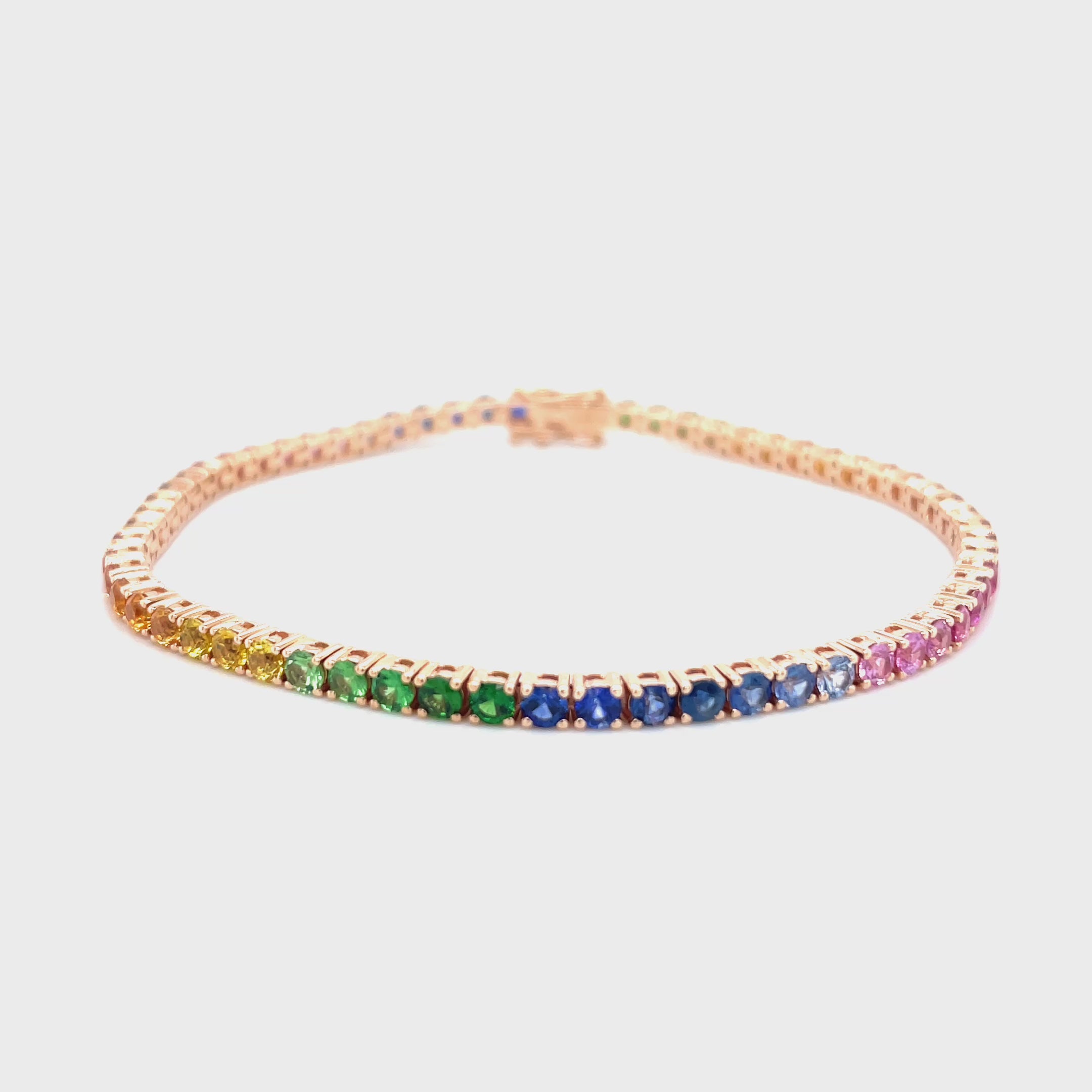 18kt rosegouden tennis armband bezet met regenboog saffier